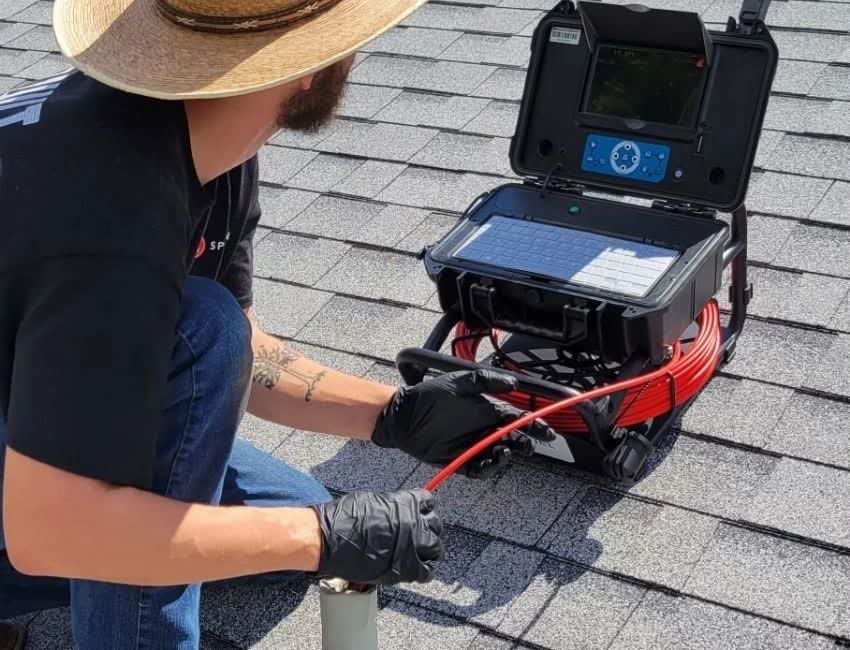 Technician running a sewer camera inspection