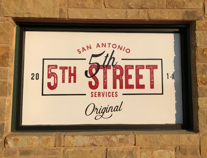 5th Street Services logo in the window of the Converse shop